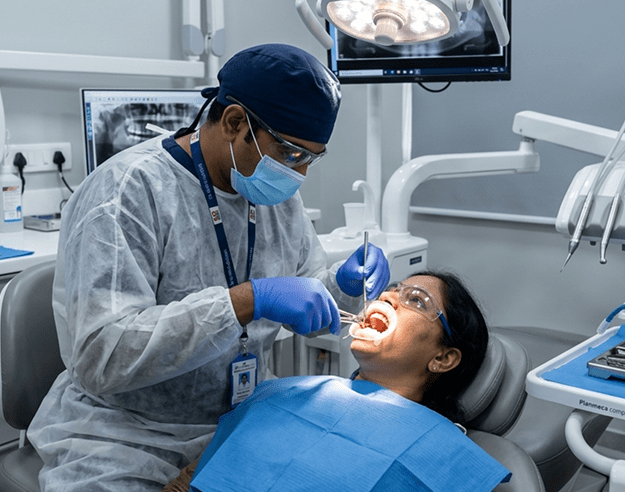 Dr. Mahantesha S consulting with a patient at Perfect Dental Studio Bangalore