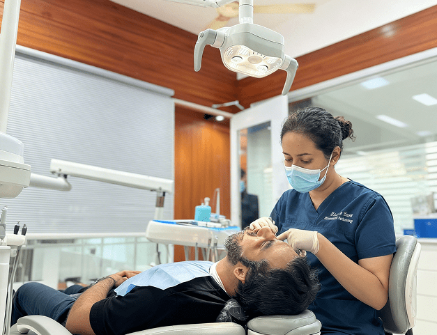 Confident woman smiling naturally after dental treatment at Perfect Dental Studio BTM Layout